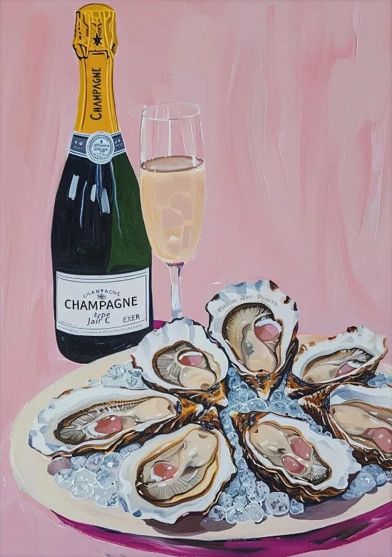 A glass of champagne next to oysters on ice on a pink plate.