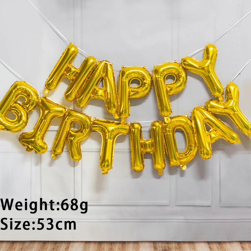 A golden foil letter birthday balloon set spelling out HAPPY BIRTHDAY hanging on a white wall.
