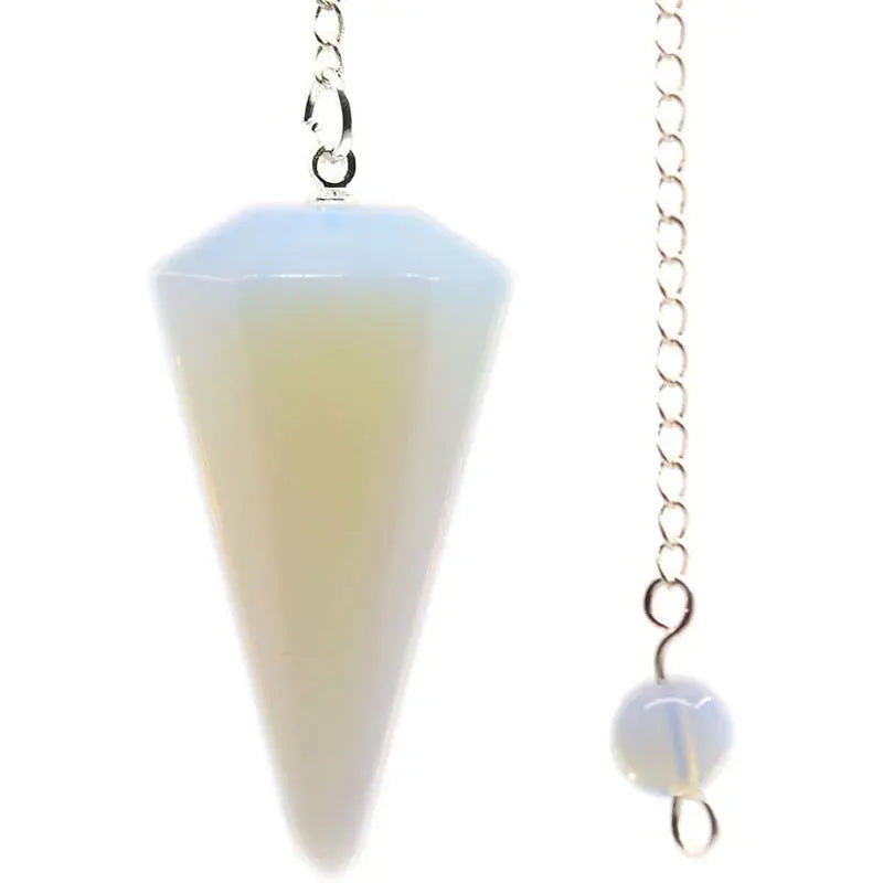 A clear, pointed natural stone pendulum with a silver chain and a polished white bead.