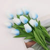 A bouquet of realistic artificial blue and white tulips with green stems.