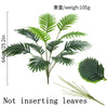 A vibrant green artificial palm tree with long, feathery fronds shown against a white background.
