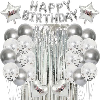 Silver and gold balloons with happy birthday lettering and tinsel streamers