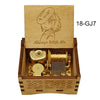 A wooden box containing a brass music box and an illustration of a character, labeled 18-GJ7.