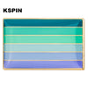 A rectangular lapel pin featuring horizontal stripes of teal, mint green, and light blue.