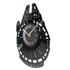 A black vinyl record wall clock with a white face and black markings, showing the time.