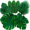 A collection of artificial tropical palm leaves in various shades of green for party decor.