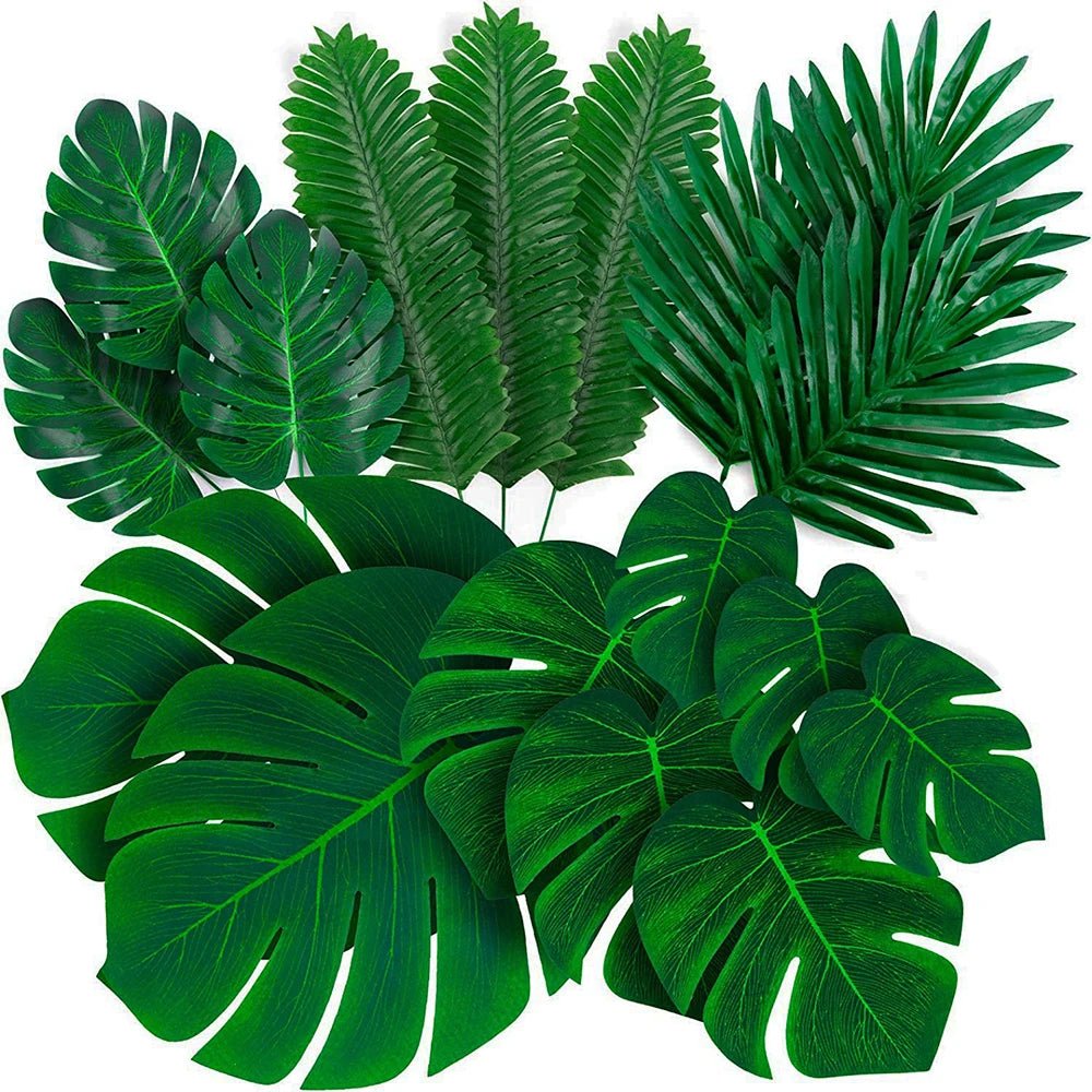A collection of artificial tropical palm leaves in various shades of green for party decor.