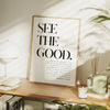 A framed inspirational quote canvas wall art poster with black text on a light background displayed on a wooden surface.