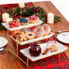 Elegant three-tier serving rack displaying seasonal fruit and baked goods on a wooden table.