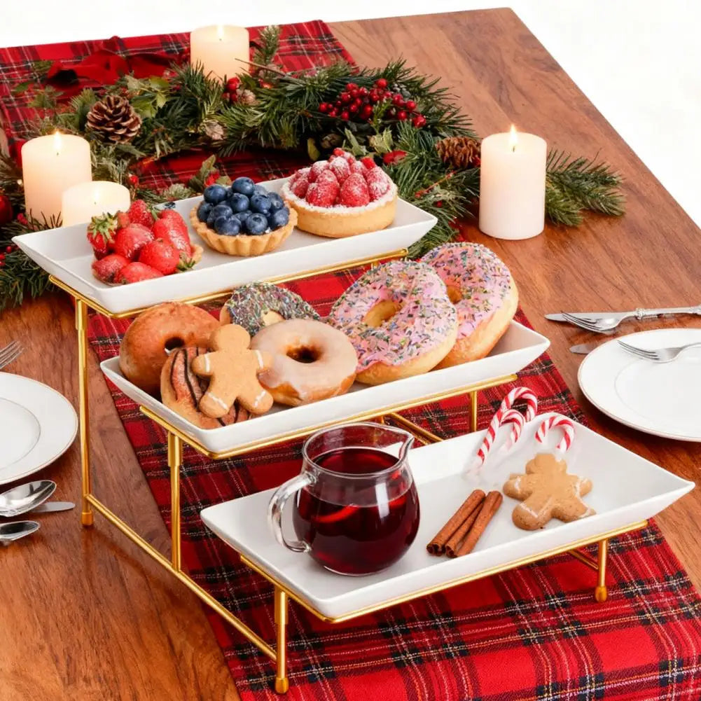 Elegant three-tier serving rack displaying seasonal fruit and baked goods on a wooden table.