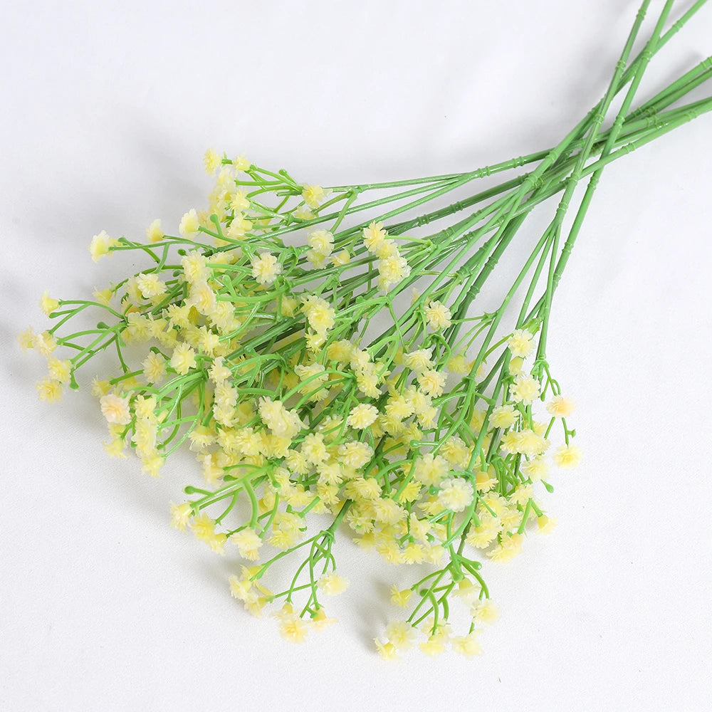 A bunch of artificial baby's breath flowers in a light yellow-green color.
