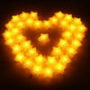 A heart shape made of bright yellow LED stars illuminating a dark background.