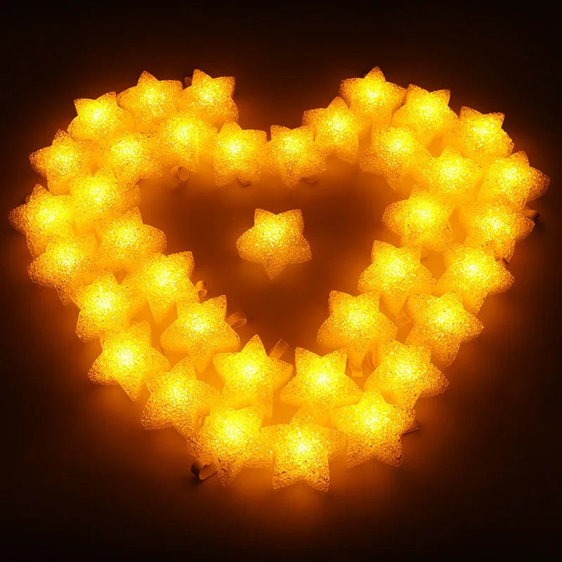 A heart shape made of bright yellow LED stars illuminating a dark background.