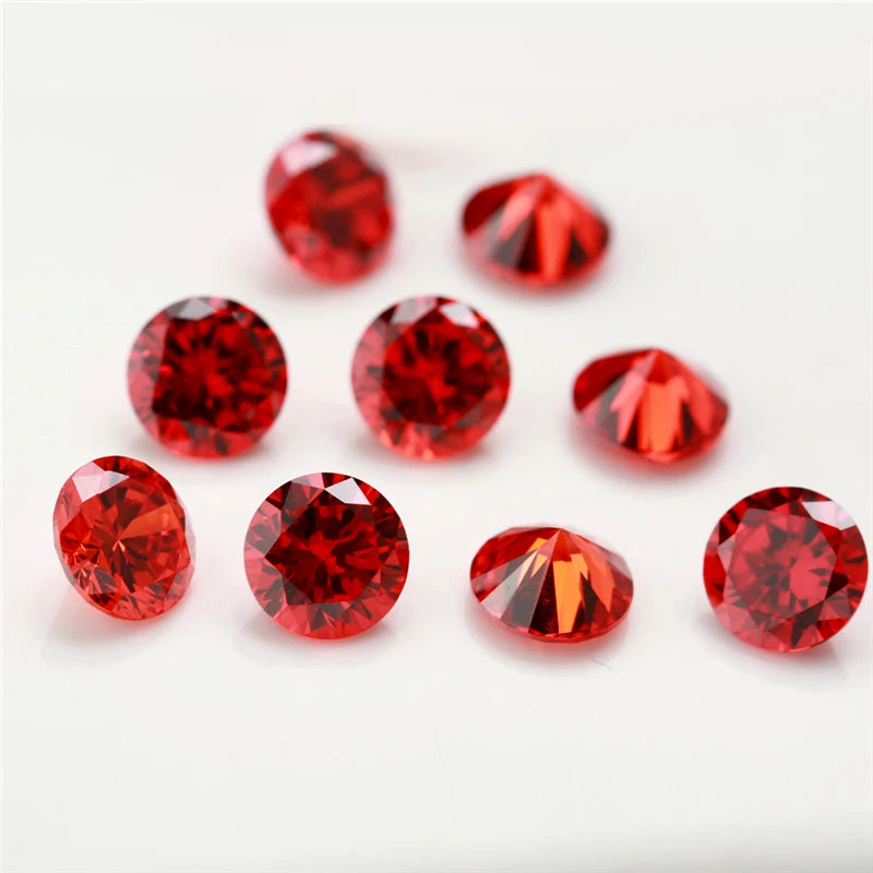 A collection of various round and triangular red gemstone loose stones for jewelry making.