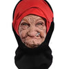 A close-up portrait of an elderly woman wearing a red headscarf mask.