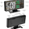 A black LED digital projection alarm clock displaying time, temperature, and humidity.