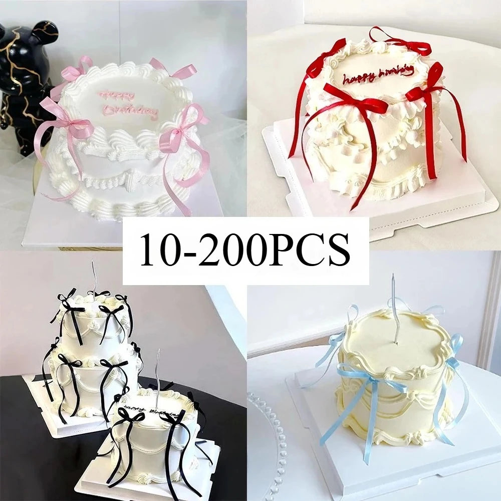 White buttercream cake with pink and red bow decorations for birthday celebrations