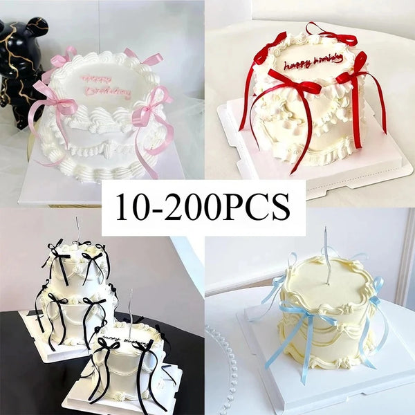 White buttercream cake with pink and red bow decorations for birthday celebrations