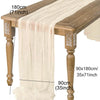 A light beige semi-sheer gauze table runner draped over a wooden table.