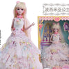 A ball-jointed doll dressed as a princess with a pink and white gown and elaborate makeup.