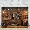 A rustic wooden barn door background featuring leather goods, hay, and antique tools.