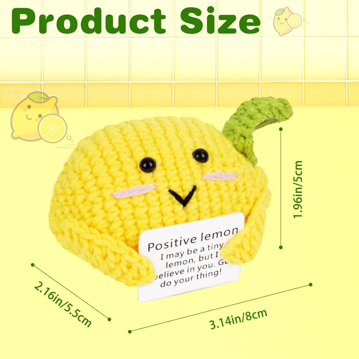 A yellow crocheted lemon-shaped dog doll with pink accents and a green ear, shown next to size measurements.