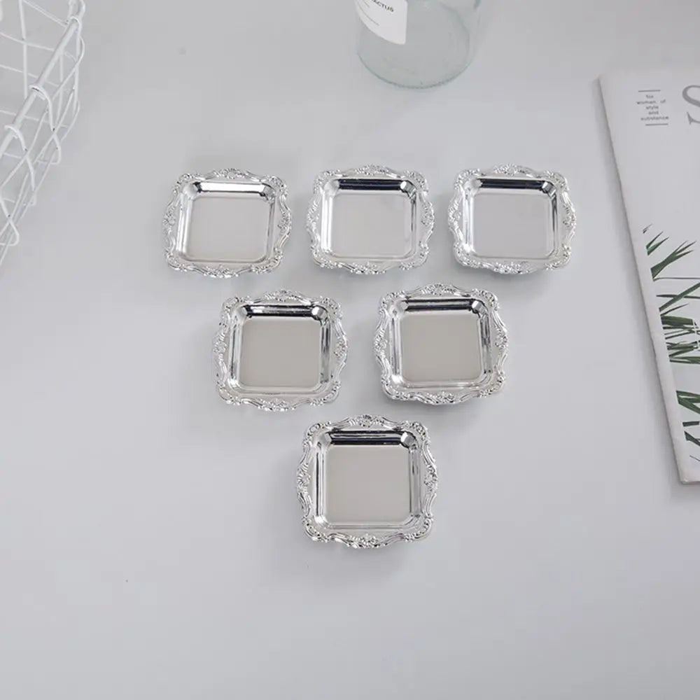 A set of ten mirror-finish mini trays for jewelry, snacks, and decor arranged on a white surface.