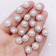 A hand displays a set of 50 pearl rhinestone flatback crystals for DIY crafts and decor.