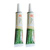 A bottle of clear adhesive for squishy toys repairs with a white cap and green label.