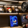 A display featuring various Sonic the Hedgehog movie posters and a large poster of Sonic the Hedgehog 3