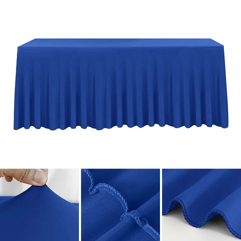 A royal blue stretch rectangle tablecloth draped over a table, showing its pleated texture and fabric quality.