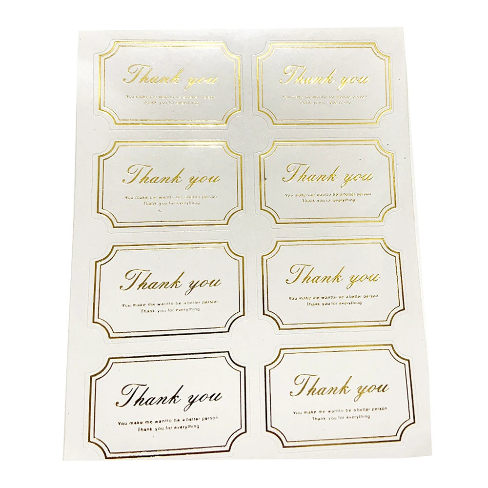 A sheet of thank you seal stickers for crafting and packaging featuring gold-edged thank you messages.