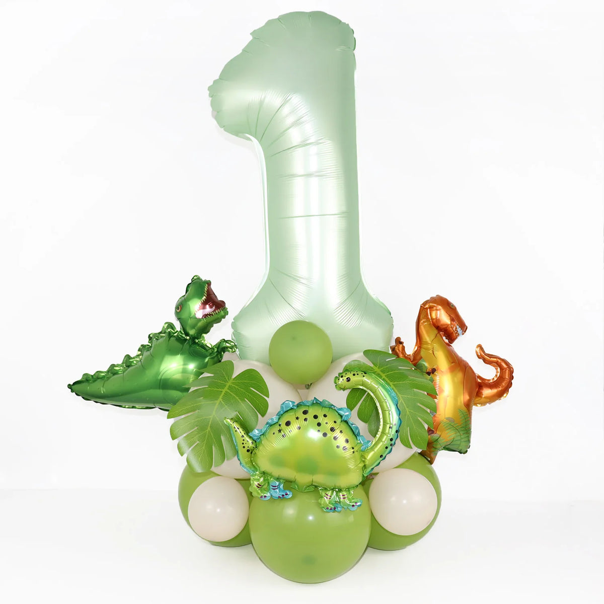 A set of foil balloons shaped like the number one and dinosaurs in avocado green and gold for a birthday decoration kit