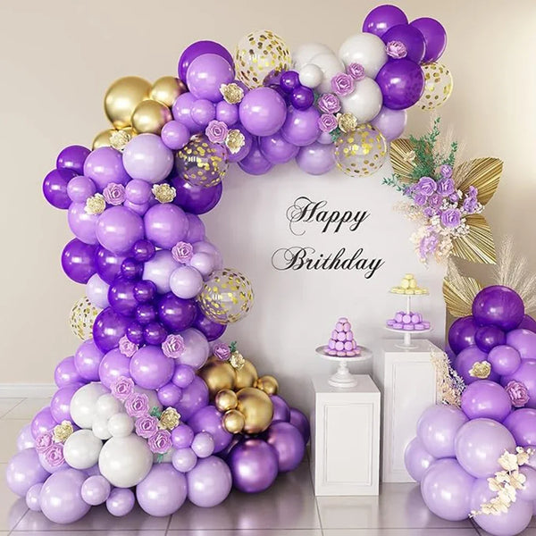 A large balloon arch decoration featuring purple and gold latex balloons for a birthday celebration.