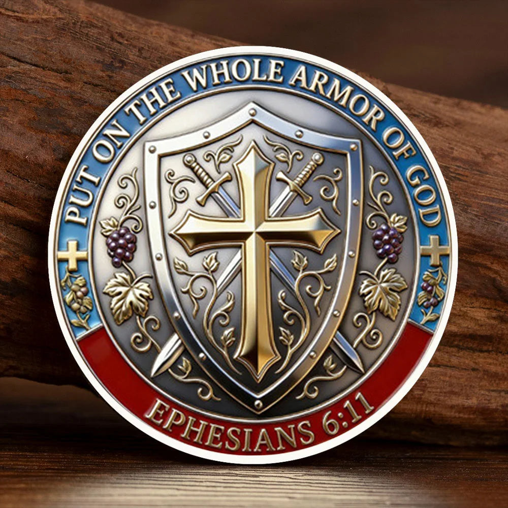 A commemorative coin featuring a silver-plated cross design and text from Ephesians 6:11, set against a wooden background.