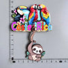 A set of wooden fridge magnets featuring Costa Rican wildlife including toucans and a sloth.