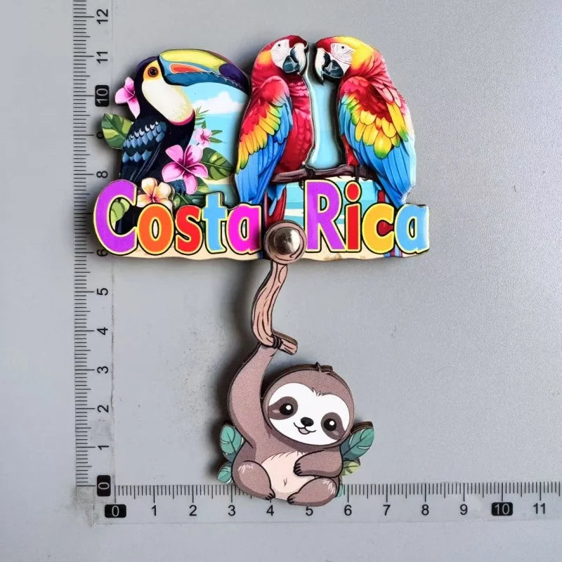 A set of wooden fridge magnets featuring Costa Rican wildlife including toucans and a sloth.