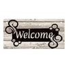 A rustic wooden hanging sign with the word Welcome carved into it on a weathered wood background.