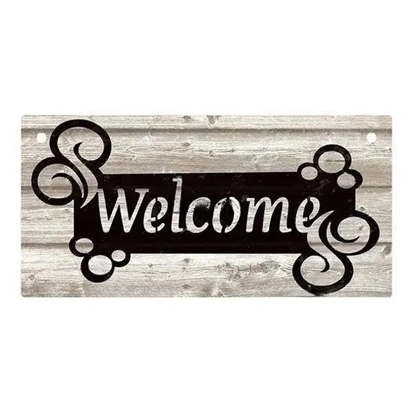 A rustic wooden hanging sign with the word Welcome carved into it on a weathered wood background.