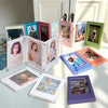 A collection of magnetic mini photo frames in various colors and sizes displayed on a white surface.