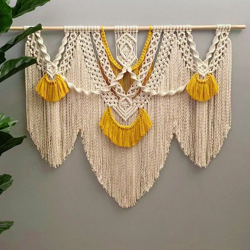 Handwoven boho macrame wall hanging tapestry featuring cream colored cords and yellow tassels