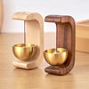 A wooden doorbell featuring a copper bell, designed as a magnetic wind chime.
