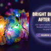 A close-up of a flower crown headband with colorful LED lights glowing between the petals.