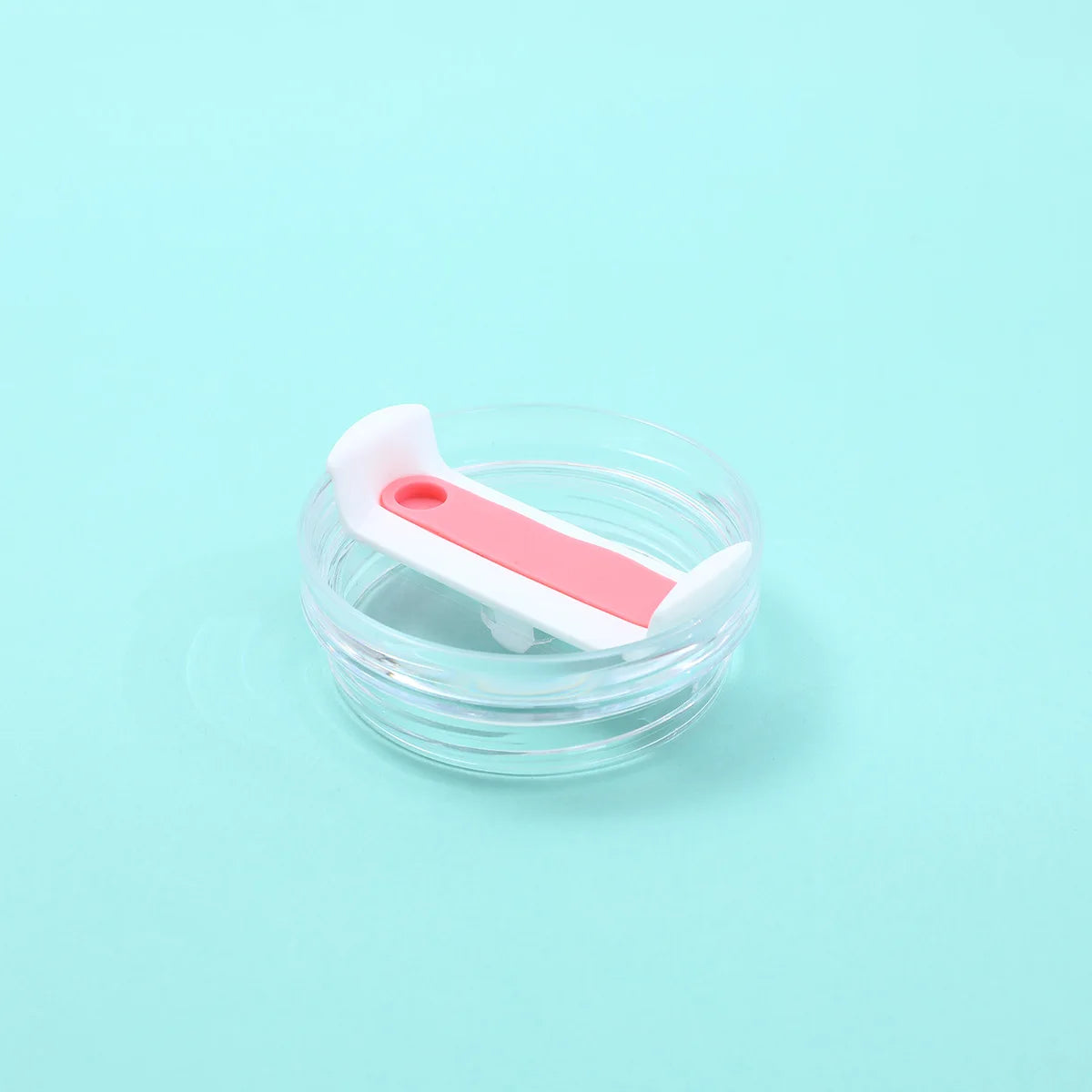 A clear silicone replacement lid with a white and pink color design for a tumbler cup.