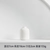 A white ceramic vase with a smooth, rounded shape is displayed on a white shelf.