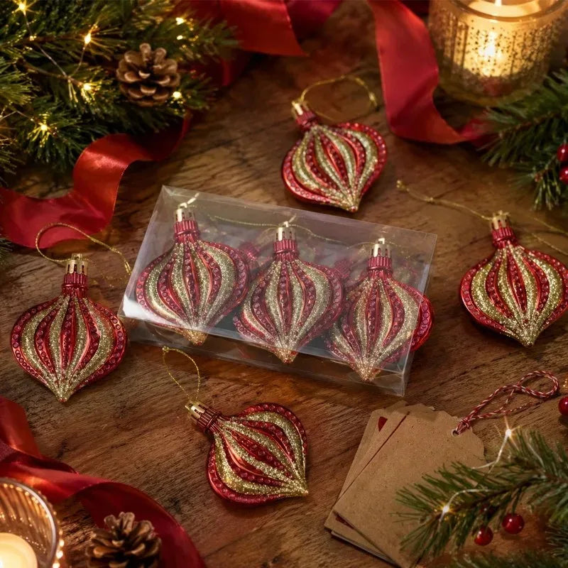 A collection of red and gold flat onion-shaped Christmas ornaments displayed on a wooden surface with pine greenery.