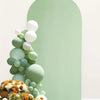 A floral and balloon arrangement against a pale green arched backdrop cover.