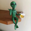 Resin green alien statue holding a glass of beer
