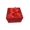 A red gift box with a satin orange ribbon tied in a bow.
