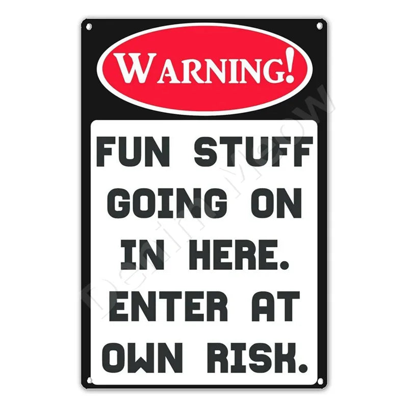 A black metal warning sign with red text that reads WARNING FUN STUFF GOING ON IN HERE ENTER AT OWN RISK.